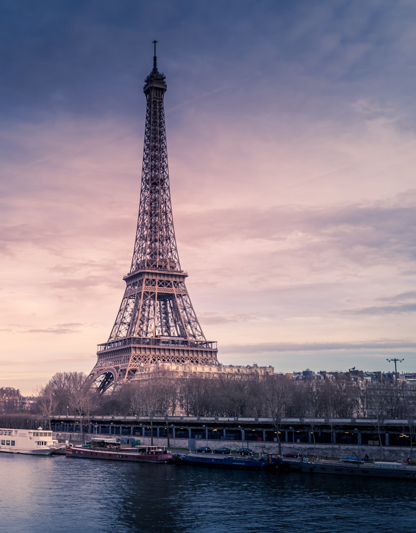 The Eiffel Tower at dusk over the Seine