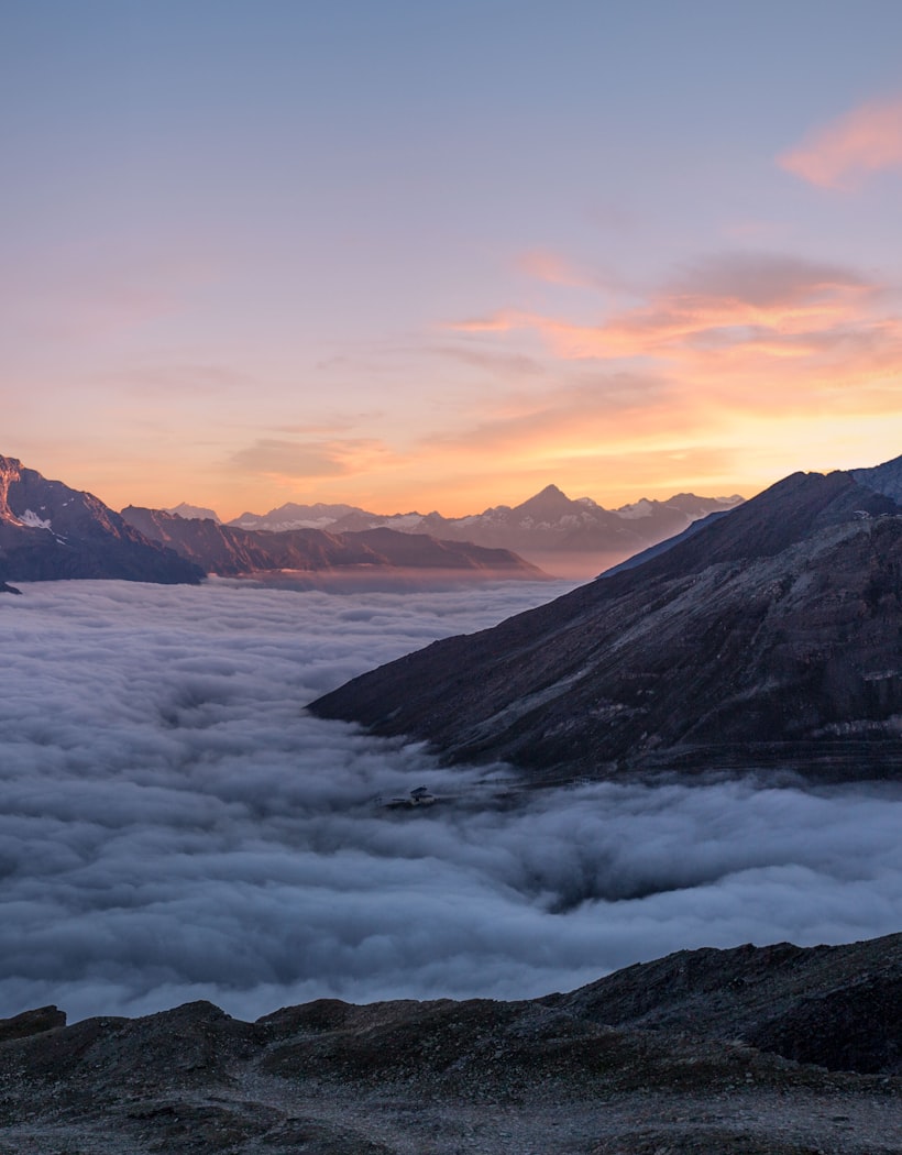 Sunrise over peaks above a sea of clouds